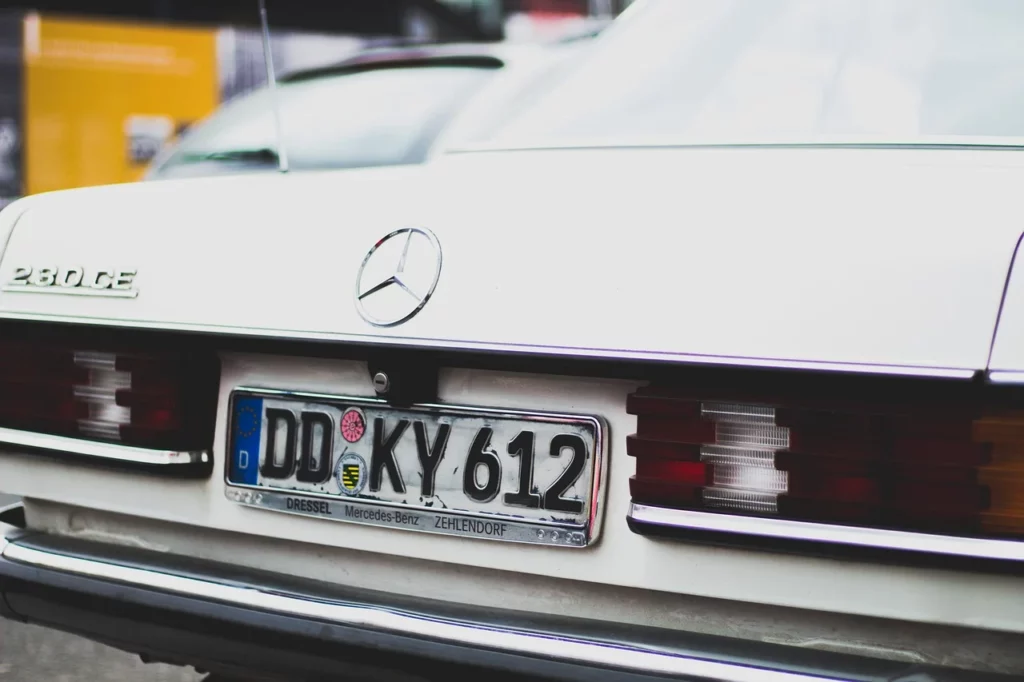 Temporary car plates issued for an imported German car, indicating the vehicle's transitional registration status in the destination country.